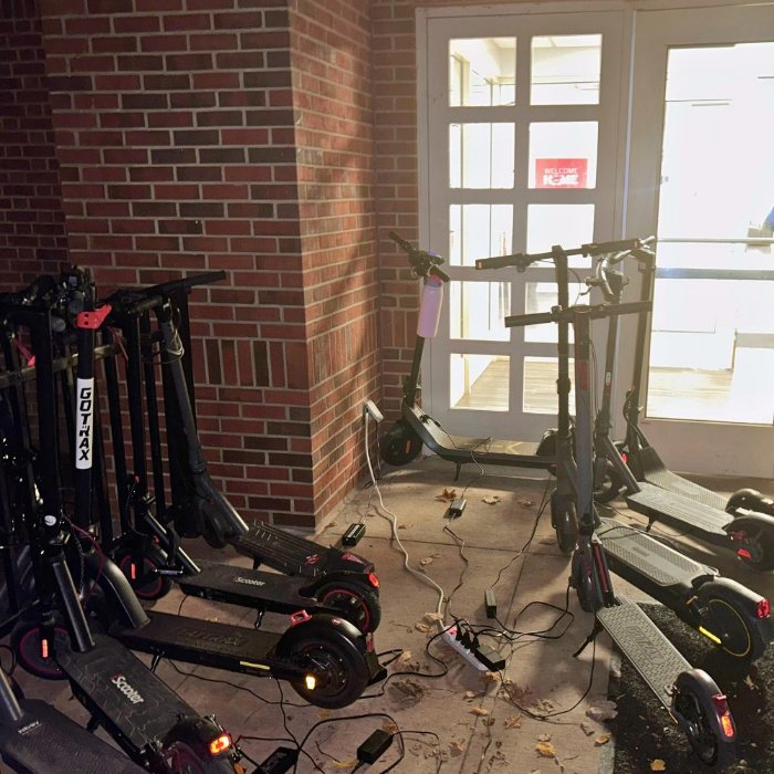 E-scooters stored indoors in a building hallway